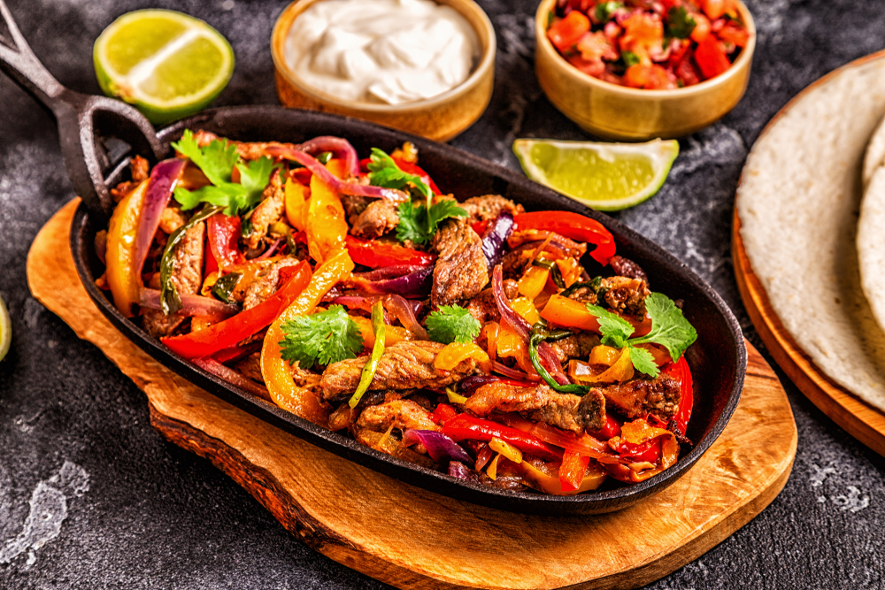 a photo of a sizzling plate of fajitas