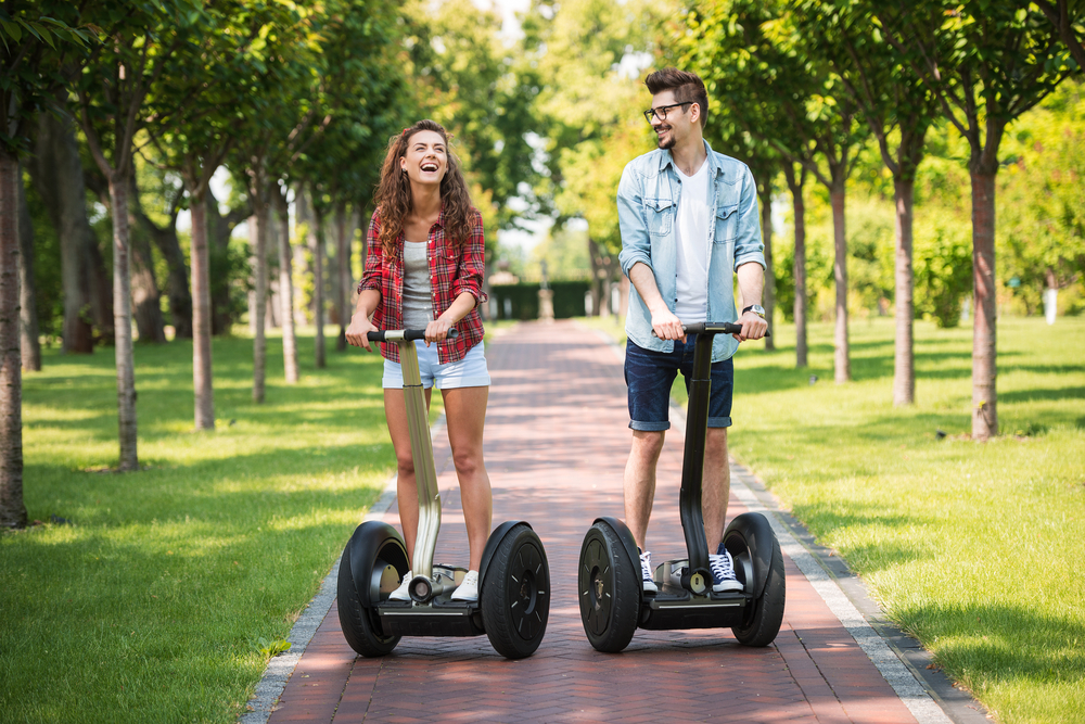 Girl and boy on segway laughing