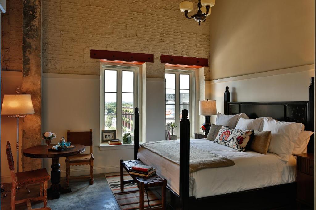 A wonderful wooden bed in a hotel room with brick walls at one of the resort hotels in Texas