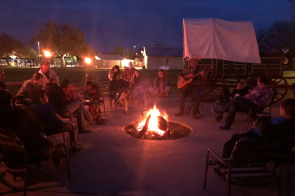 People sitting around the camp firs at the Flying Ranch one of the resort hotels in Texas