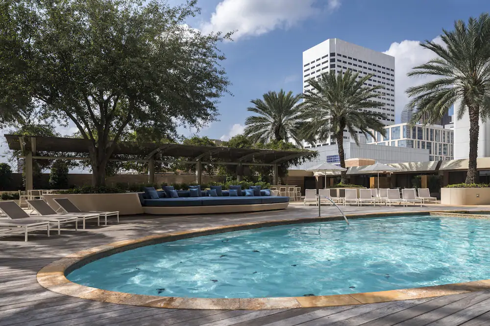 Hotel pool with huge blue lounger in the Four Seasons Hotel Houston