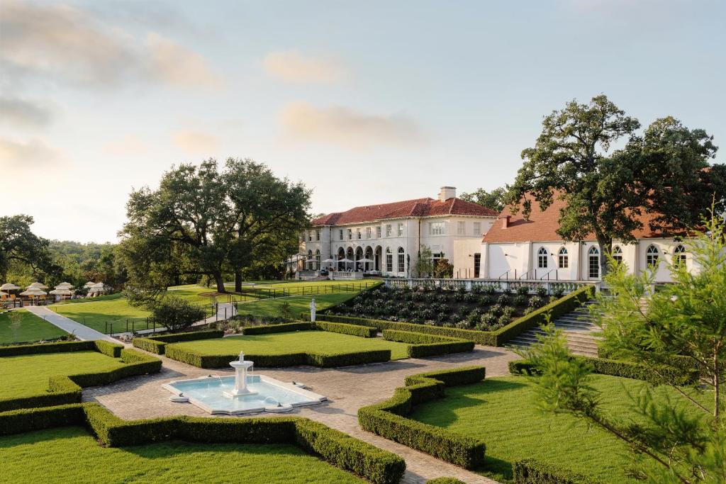 The outside terrace, lawns and fountain at The Perry Estate