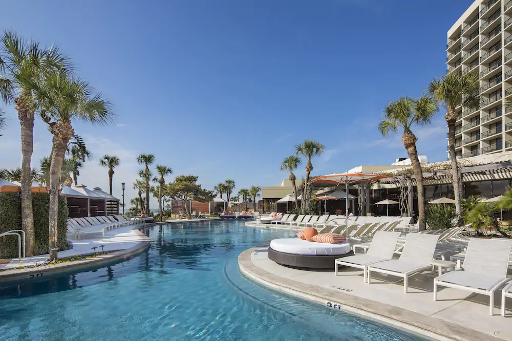 A swimming pool surrounded by chairs in one of the resort hotels in Texas