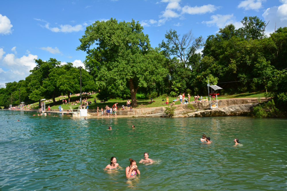 people swimming in the water and enjoying at the shore beaches in austin