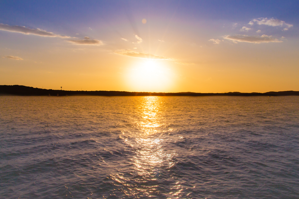 sunset over water beaches in austin