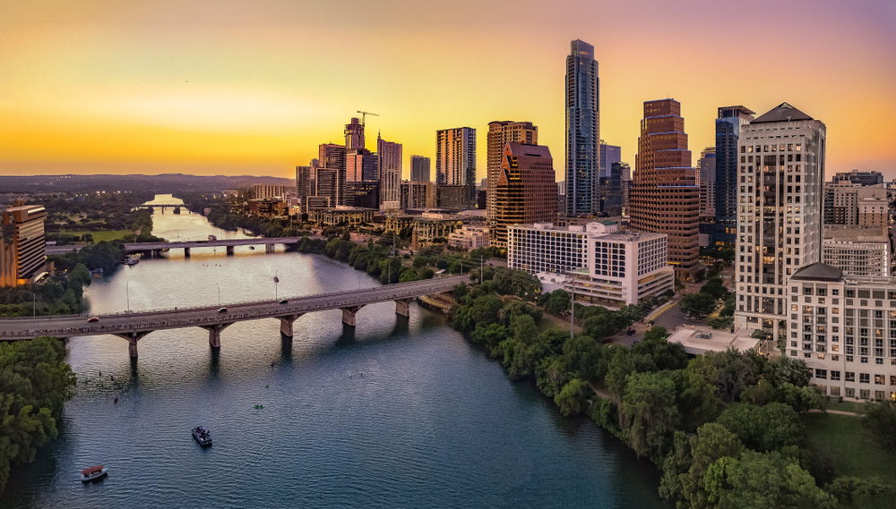 aerial view of city with bridge and river beaches in austin