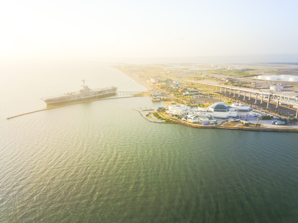 aerial view of beach, a ship, and the city beaches in corpus christi