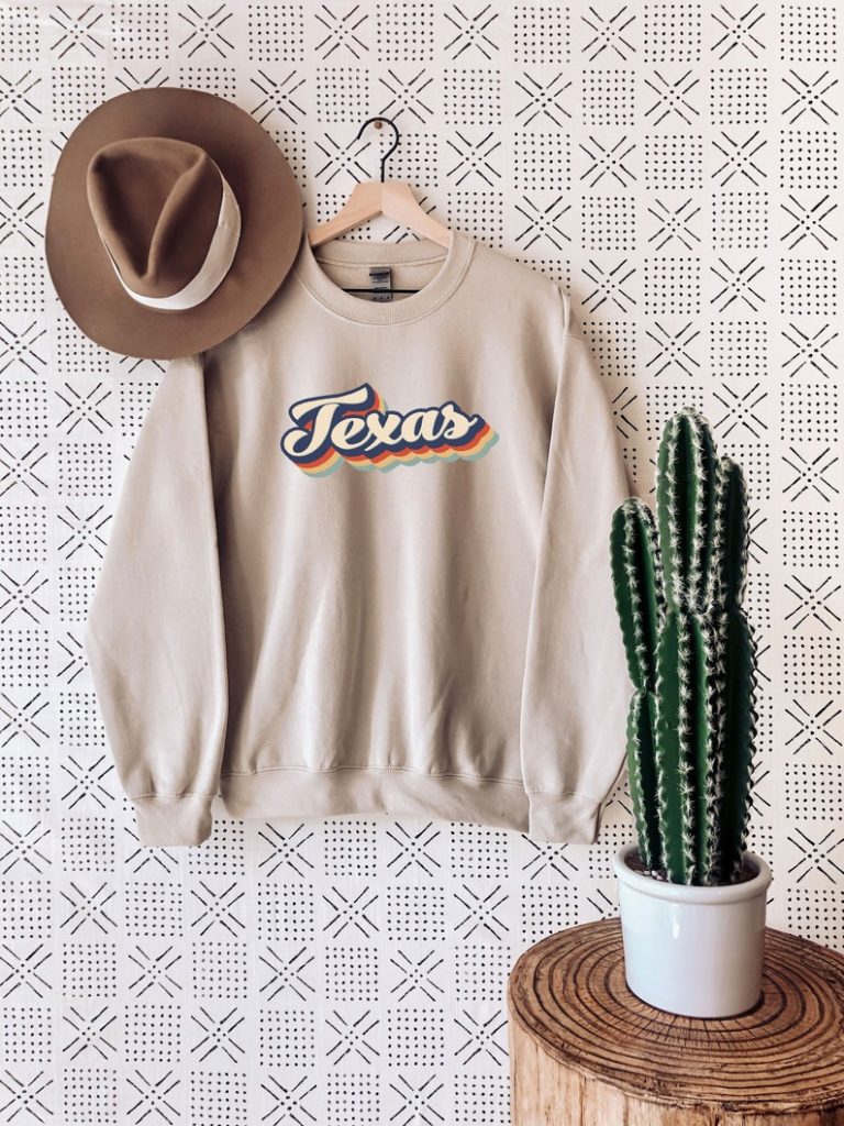sweatshirt on a hanger with cactus and a hat texas gifts
