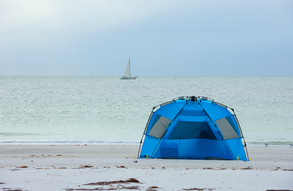 Tent camping on a white sandy beach