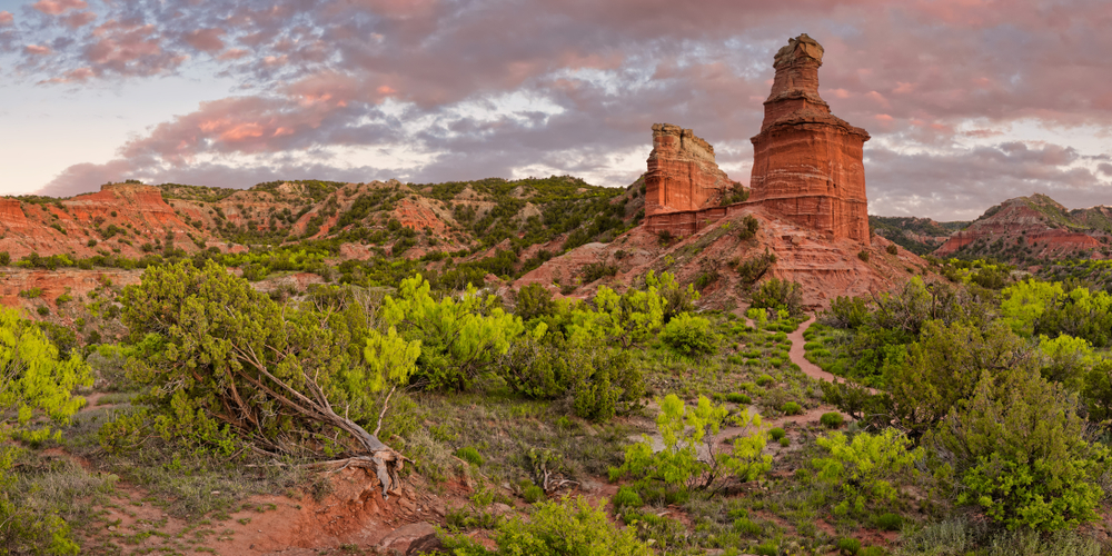 sunset over rock surrounded by vegetation route 66 in texas