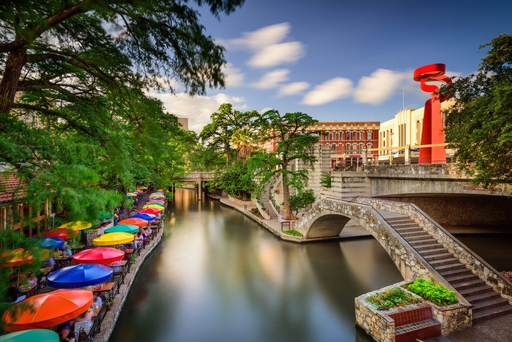 The San Antonio Riverwalk with colourful umbrellas lining the street