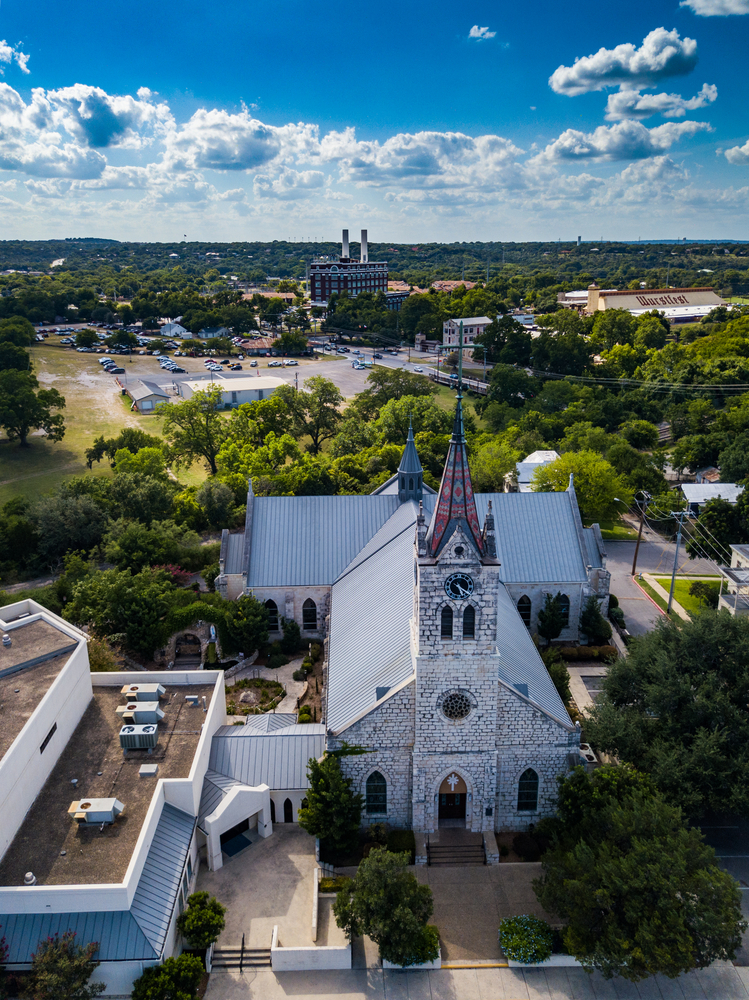 Aerial view of New Braunfels showing a white church and the town in the background