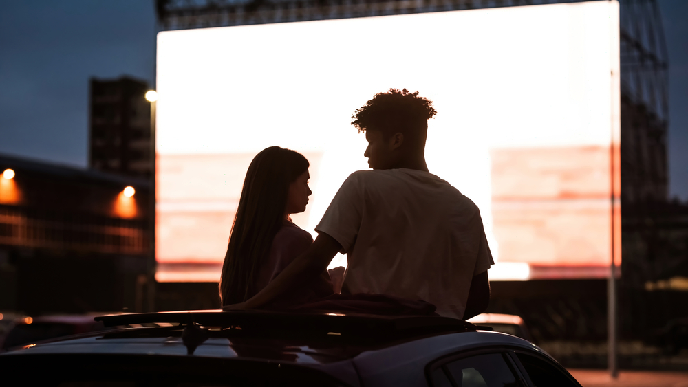 couple watching a drive-in movie date night in houston
