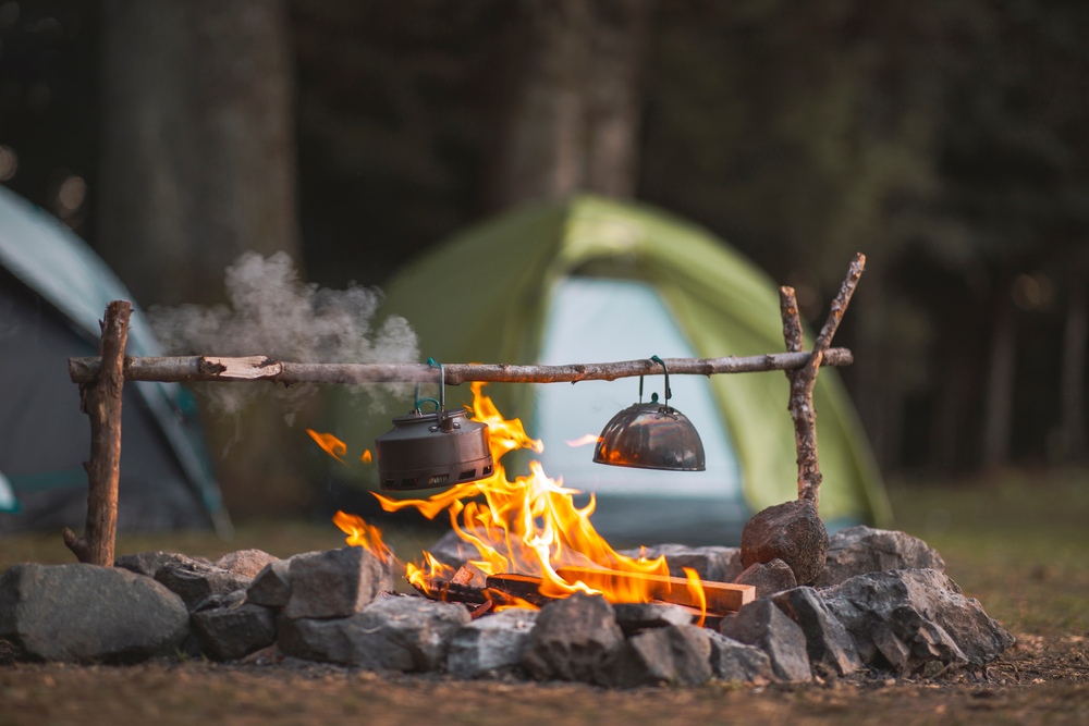 camping tent with a tea pot over a fire pit things to do in lake travis