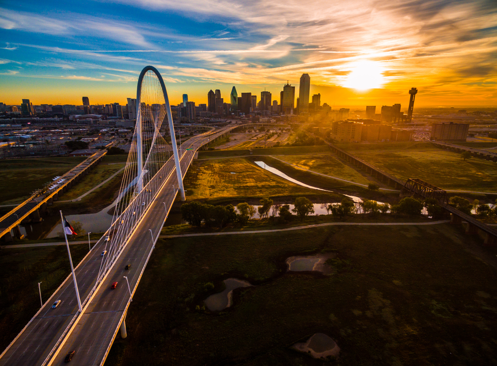 aerial view of city with bridge during sunset