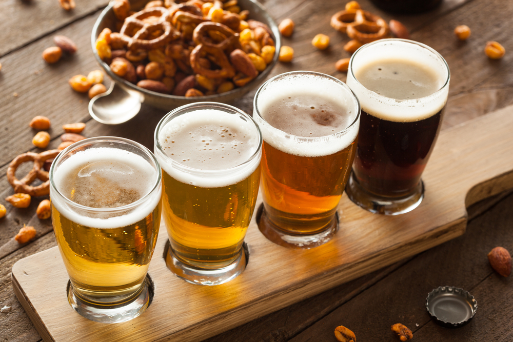 assorted beers with snacks places on a wooden tray best breweries in san antonio