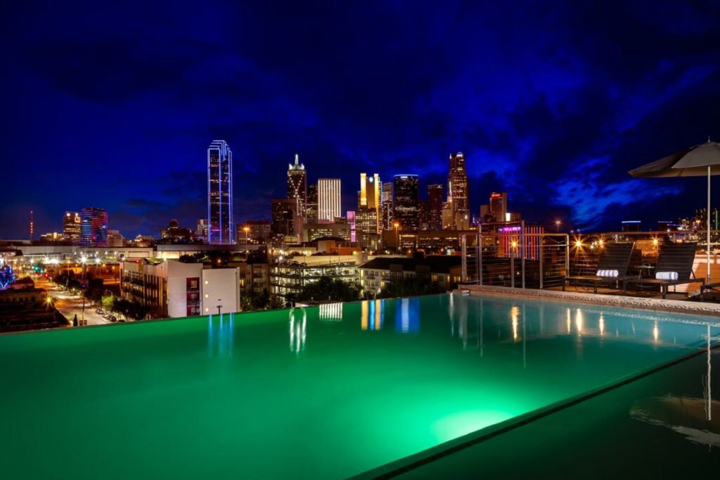 outdoor pool at night with city views