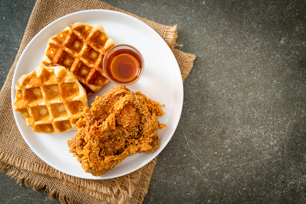 fried chicken waffle with honey served on a white plate best restaurants in south padre island