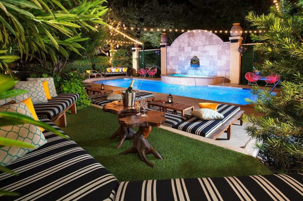 lawn with cushioned seating area and a pool best boutique hotels in dallas