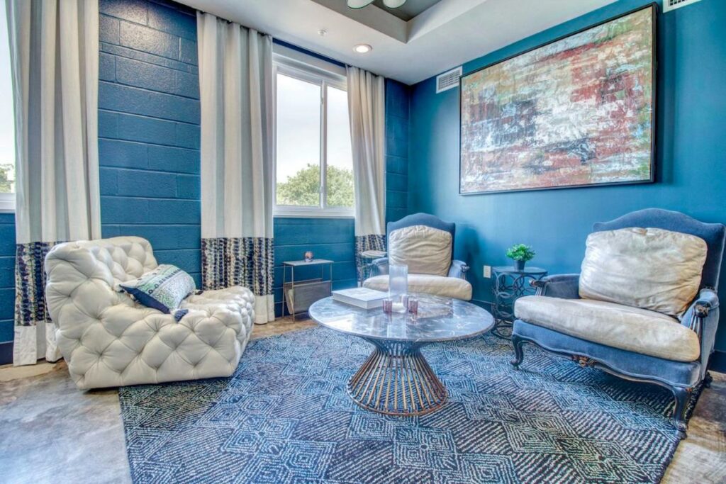 room with blue-colored walls and sofa set best boutique hotels in dallas