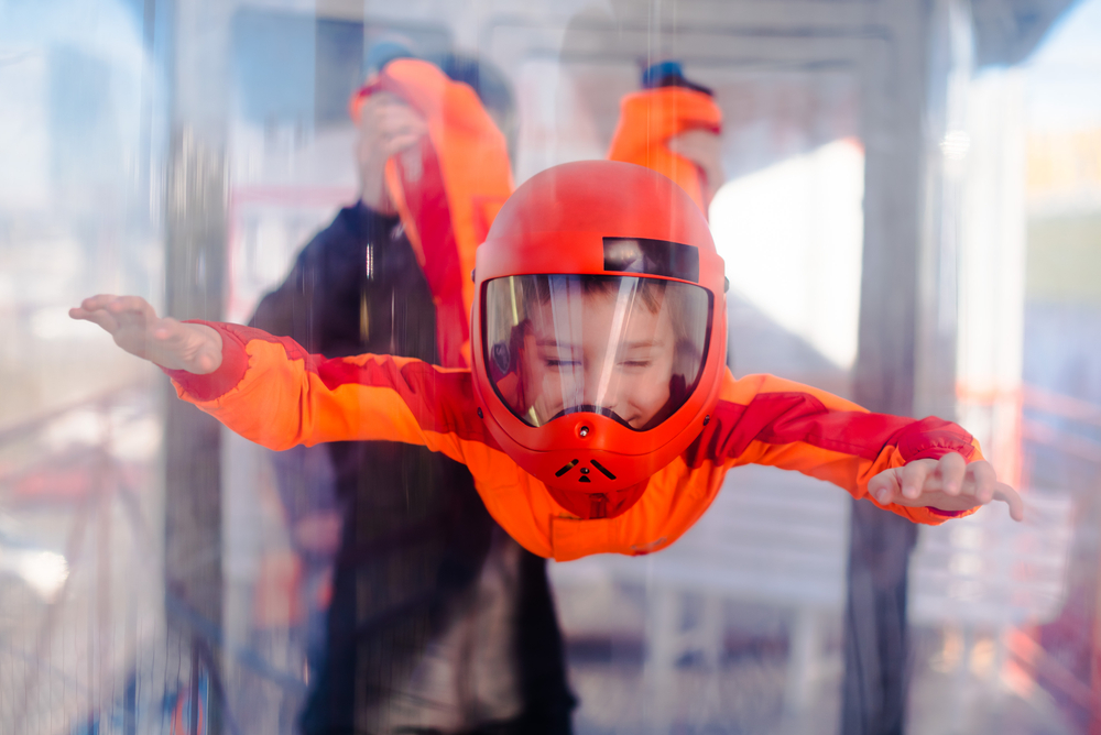 Kid flying in an indoor skydiving facility best things to do in Austin at night