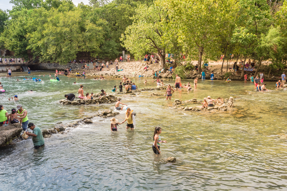 people enjoying in the water surrounded by trees best things to do in Austin at night