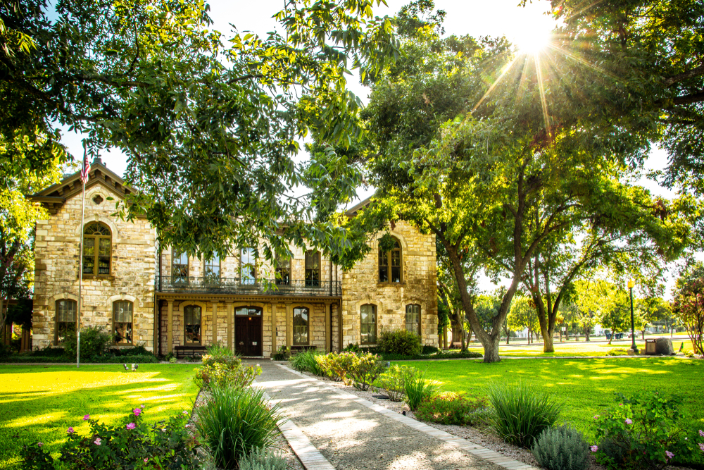 Pioneer Memorial Library surrounded by tress in Fredericksburg.