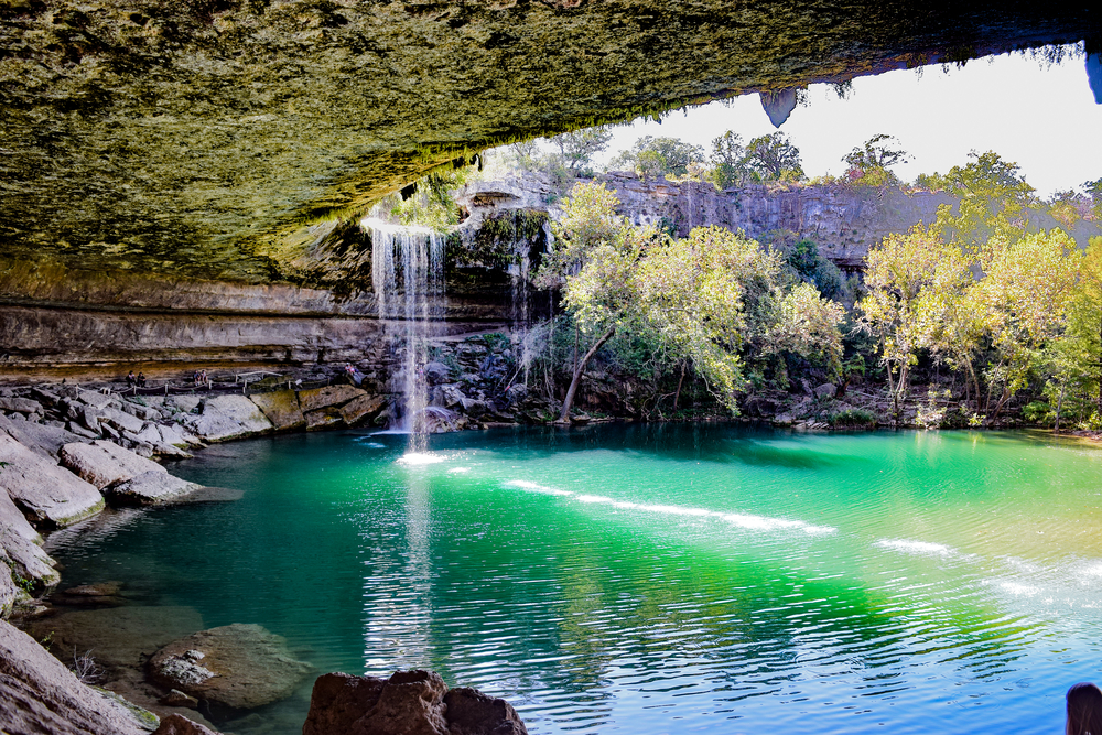 View of the waterfall at Hamilton Pool from under the rocky outcropping.