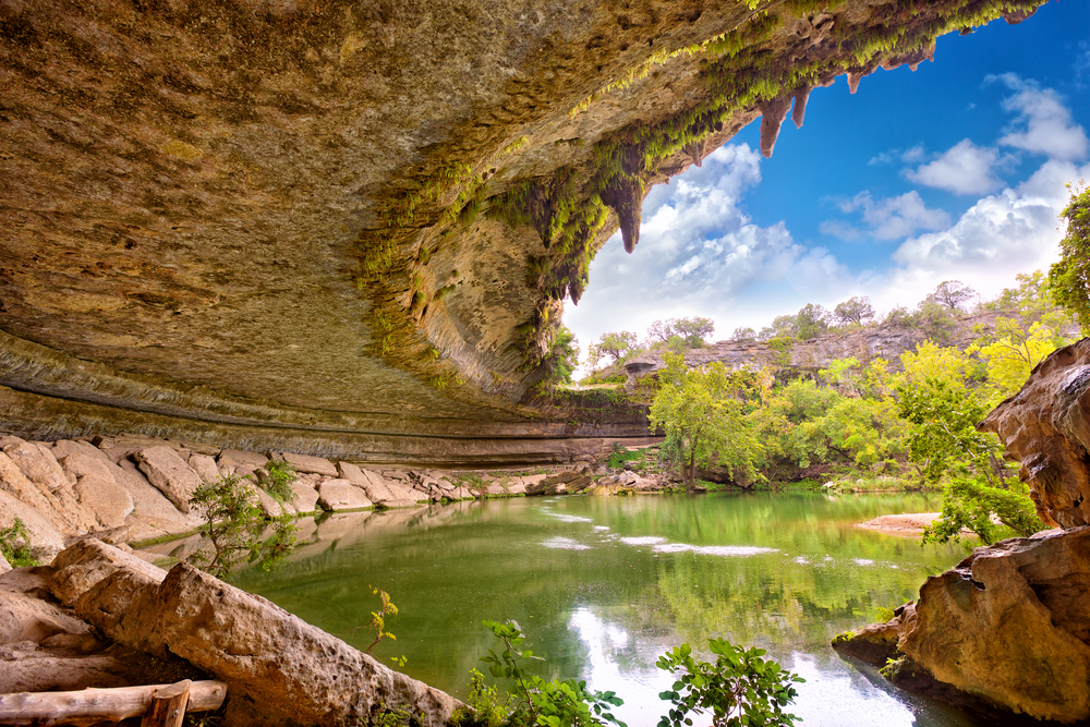 Hamilton Pool is surrounded by pretty trees in the fall.