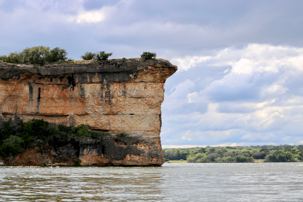 Large Cliff face sticking out of the water on a lake