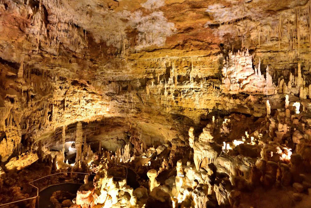 Inside Natural Bridge Caverns with many stalagmites.