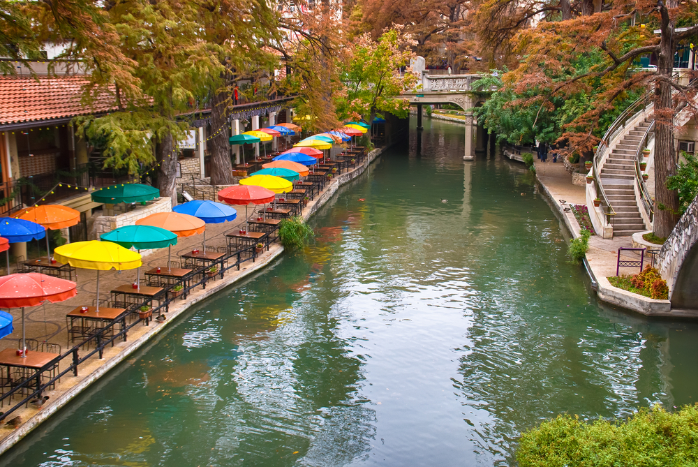 photo of a bridge and restaurant seating on the San Antonio riverwalk 