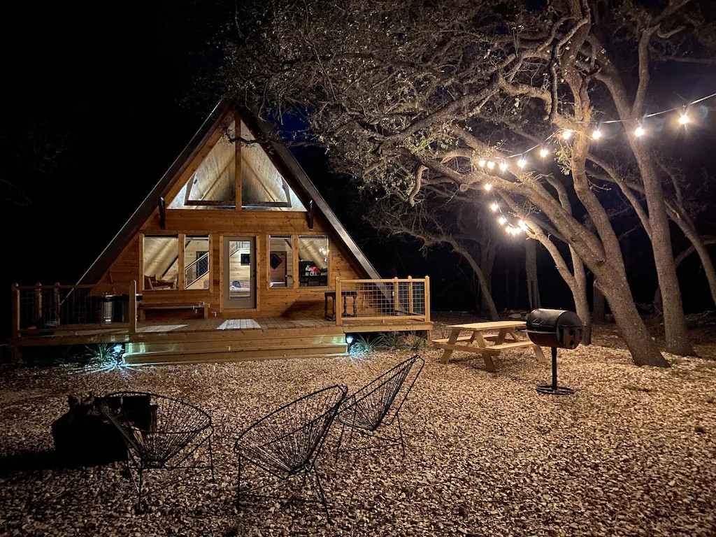 a-frame cabins in texas with fairy lights at night