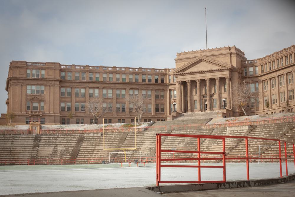 El Paso hIgh school an old styled large building with a football field in front 