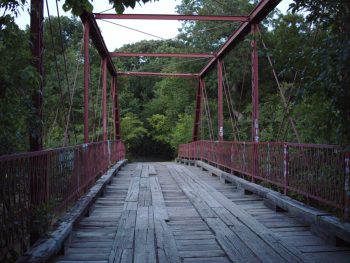 old alton bridge with trees in the background one of the most haunted places in texas