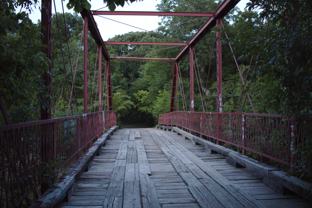 old alton bridge with trees in the background one of the most haunted places in texas