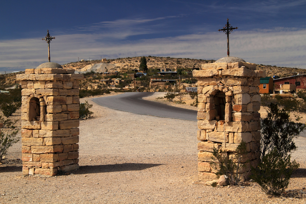 Two stone pillars with crosses on top at the entrance to Terlingua Ghost Town