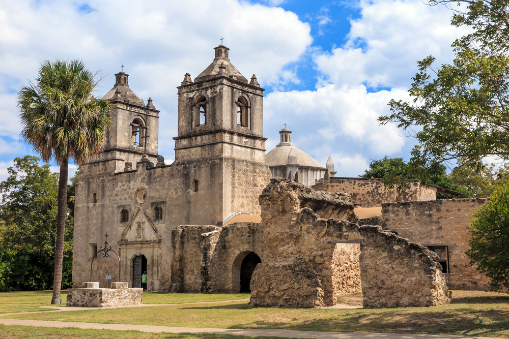 a stone building with two towers on a sunny day