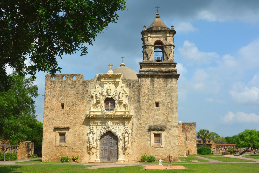 one of the Spanish missions in Texas made of stone on a sunny day