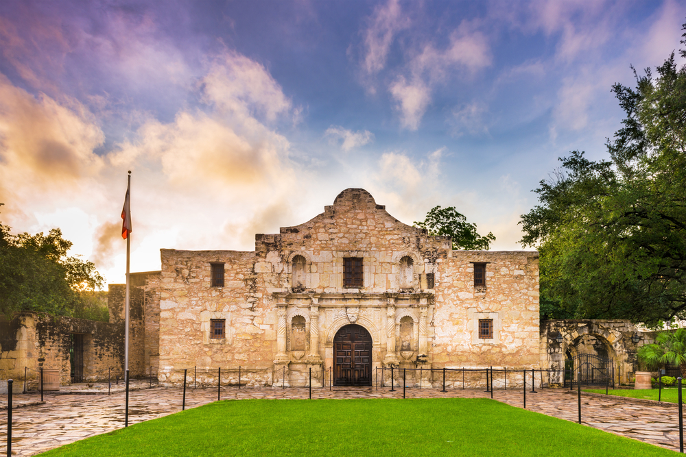 a church made of stone with the Texas flag in front, a must visit Texas Hill Country attraction