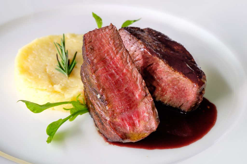 Wagyu Beef on white plate with mashed potatoes