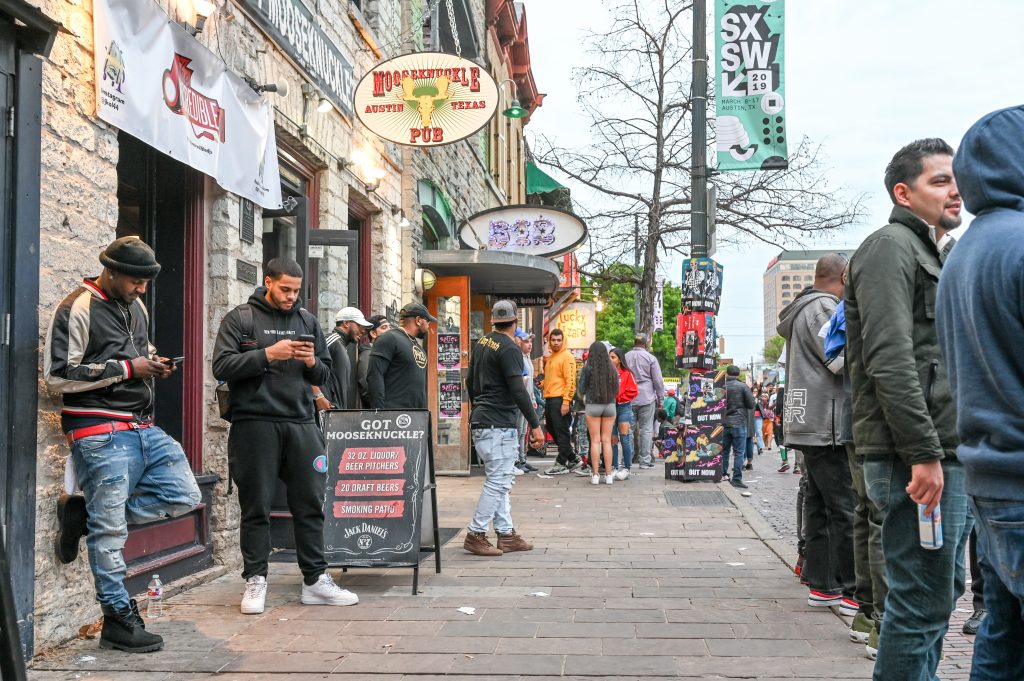 Crowds line the sidewalks on Sixth Street, the center of Austin's entertainment district