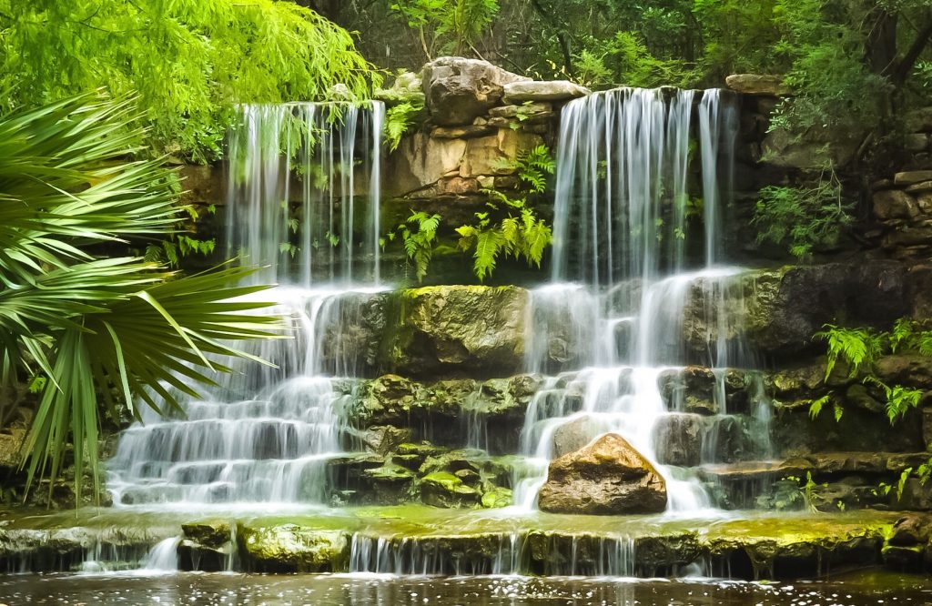 A closeup of a small waterfall cascading over rocks