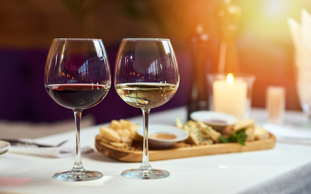 A glass or red wine and a glass of white wine in an upscale restaurant in Fredericksburg.