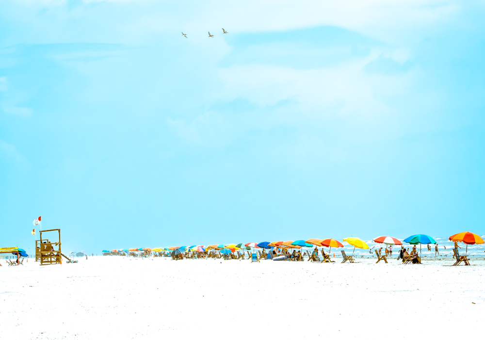  a row of colorful umbrellas along Stewart Beach in texas