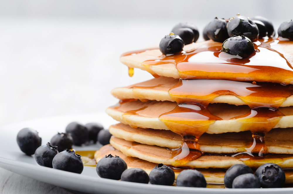 Blueberry pancakes covered in syrup at best breakfast restaurant in Dallas 