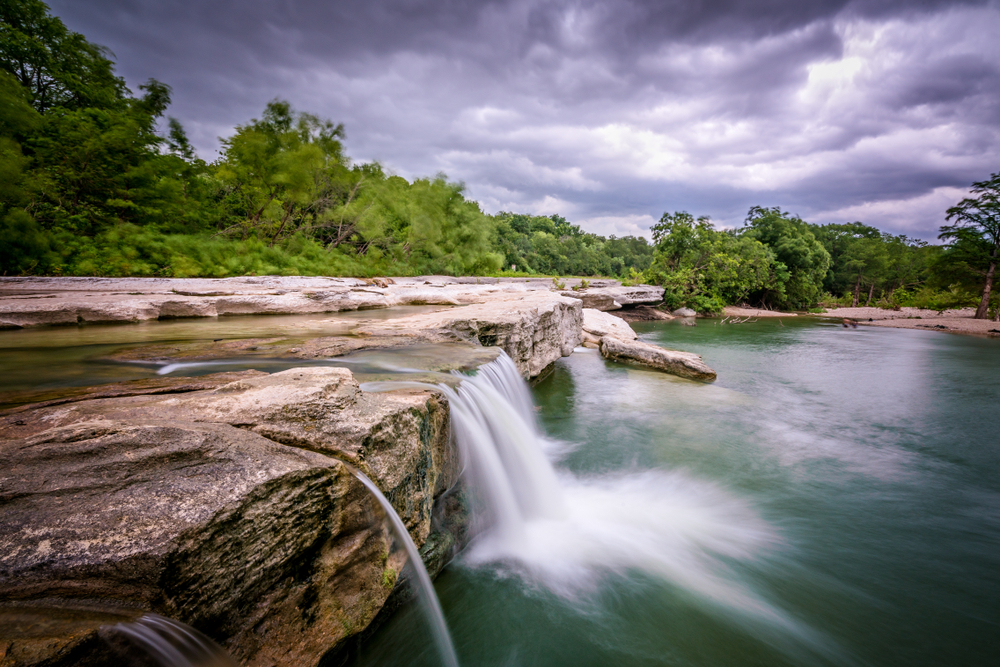 waterfall with purple sky one of the best day trips from austin texas