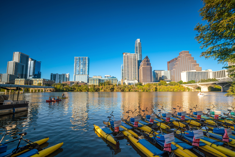 Kayaks seen below the Austin skyline - a perfect place to go kayaking in Texas!