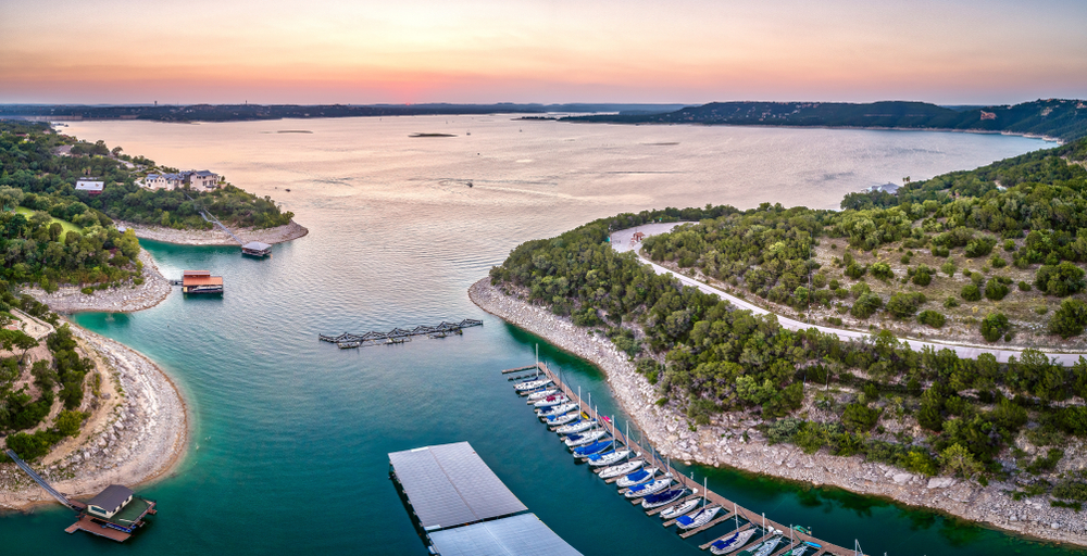View overlooking a large lake and marina full of colorful boats at sunset at one of the best swimming holes in texas