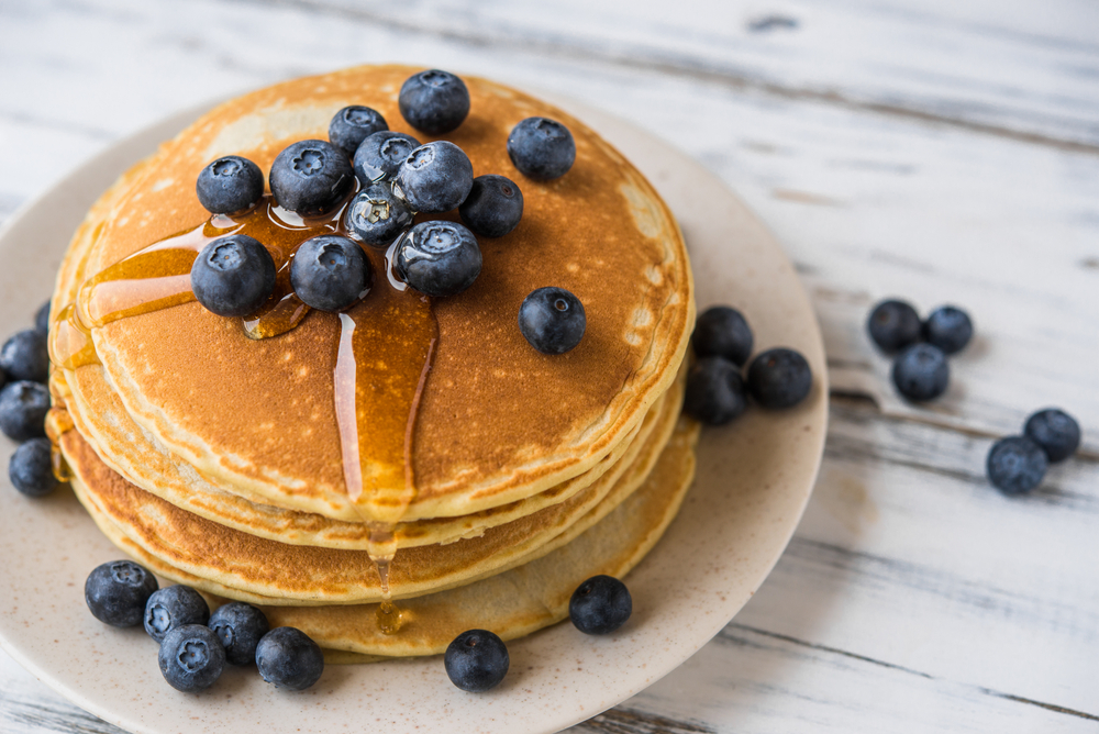 Plate of pancakes with fresh blueberries on top at restaurant in El Paso 